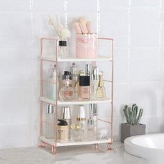 a bathroom shelving unit with cosmetics and toiletries on it next to a bathtub