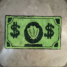 a green rug with dollar signs on it