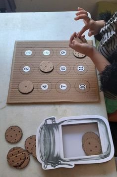 a child is making a cookie board with buttons