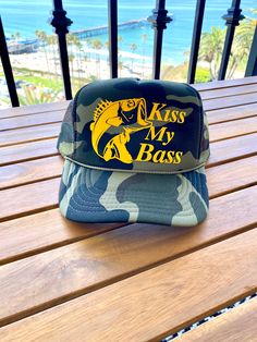 Kiss My Bass Fish Camo Foam Trucker Hat | Fisherman Fishing Hats Custom Hats Cowboy Hat Trip Summer Boat Coastal Trucker Hat Camouflage , adjustable, Mid Rise Unisex Trucker Hat! adult sizing; adjustable strap in the back one size fits most! Summer Fishing Trucker Hat With Curved Brim, Summer Fishing Trucker Hat, Summer Trucker Hat With Curved Brim For Fishing, One Size Fits Most Snapback Fishing Hat, One Size Fits Most Snapback Fishing Cap, Adjustable Green Bucket Hat For Fishing, Khaki Fishing Cap, Khaki Cap For Fishing, Curved Brim Trucker Hat For Fishing