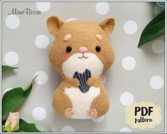 a stuffed animal is hanging on a polka dot wallpaper with leaves and flowers in the background