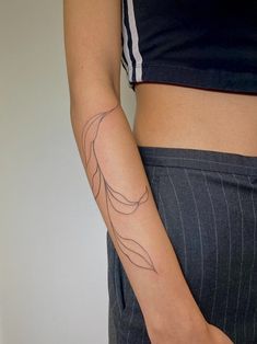 a woman's arm with a tattoo on the left side of her right arm