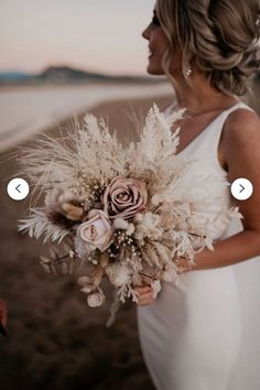 a woman in a white dress holding a bouquet