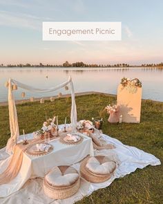 a table set up for an outdoor dinner by the water