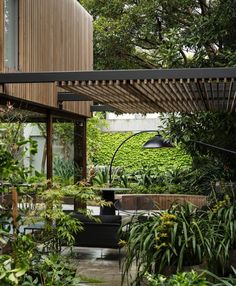 an outdoor living area with lots of greenery