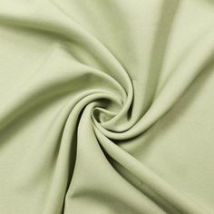 a close up shot of a plain light green fabric