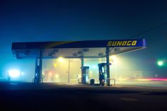 the sunoco gas station is lit up at night