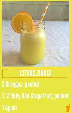 an orange smoothie is in a jar with a straw