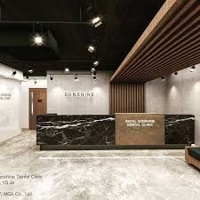 an office lobby with marble counter tops and wood accents