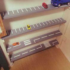 toy cars are lined up on the shelves