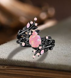 Unique Pear Pink Fire Opal Engagement ring Set Gothic Art deco Black Gold Cluster Vine Leaf Wedding Band Vintage Stacking Bridal Promise Set Applicable scene: anniversary, birthday party, wedding, engagement, gift ■ Handmade, high-quality item! ■ Material: S925 Sliver SOLID 14K/18K BLACK GOLD (can be made in white/rose/yellow gold) Engagement ring ■ Center stone: Pink Opal ■ Size/Weight: 6*8mm pear ■ Side stones: Pink Opal ■ Total weight: 0.042 ct (High Quality) ■ Cut - VG ■ Color: G-H ■ Clarity: SI-VS Wedding band ■ Side stones: Pink Opal/Moissanite ■ Total weight: 0.37 ct (High Quality) ■ Cut - VG ■ Color: G-H ■ Clarity: SI-VS ■Or Side stones diamonds PRODUCTION I'm a jewelry crafter, I've been making jewelry for 30 years Each piece of jewelry we make by hand and polish the quality with Unique Purple Engagement Rings, Black And Pink Wedding Rings, Unique Opal Engagement Rings, Ethereal Wedding Rings, Engagement Ring Not Diamond, Black Band Engagement Ring, Engagement Rings Fairy, Goth Wedding Rings, Flashy Engagement Rings