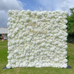 a large white flowered wall in the middle of a field