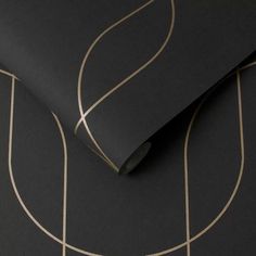 a black and gold wallpaper with lines on the bottom, along with a circular design