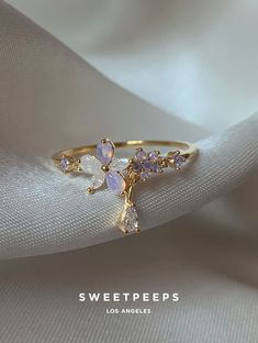 Product Details + Care   - 18K Gold Dipped Over Brass  - Brass: Copper + Zinc Alloy  - 1 Ring  - Wipe Clean   - Imported              Dimensions  - Size is 6               Have a question? Please message info@shopsweetpeeps.com and our support team will get back to you in 48 hours. Rings Engagement Flower, Rings That Dont Tarnish, Rose Gold Aesthetic Jewelry, Purple Flower Ring, Julery Aesthetic, Cute Rings For Teens, Cute Promise Rings Girlfriends, Cute Rings Gold, Cottagecore Rings