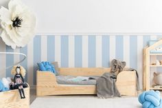 a child's bedroom with blue and white striped walls