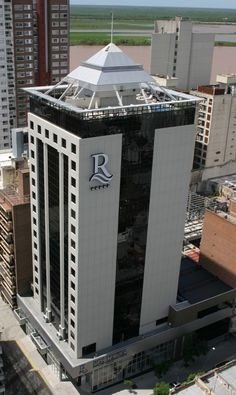 an aerial view of a large building in the middle of a city with tall buildings