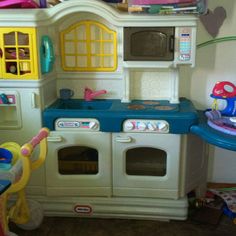 a child's play kitchen with lots of toys