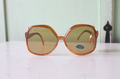 "1970s RARE Deadstock Sunglasses Glass Lenses- Impact Resistant Sticker still on lens Wonderful vintage condition Very rare deadstock Tinted Lens as seen in picture non-prescription amazing style Made in Taiwan 5.5\"total width 2 1/2\"lens width 5 1/4\"arms length Thank YOU and please feel free to ask me any ?s:) Have a lovely day xoxo www.etsy.com/shop/retroandme **on cardboard stand" Funky Sunglasses Vintage, 60s Sunglasses Vintage, Glasses 70s Eyewear, 1960s Sunglasses, 1970s Sunglasses, 70s Glasses, Nice Glasses, Mod Girl, Red Sunglasses