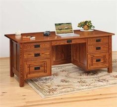 a wooden desk with two drawers and a laptop on it