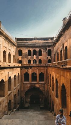 a man standing in the middle of an old building