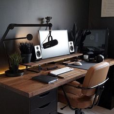 a desk with a computer and speakers on it