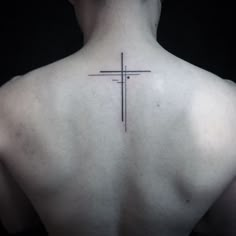 a man with a cross tattoo on his back