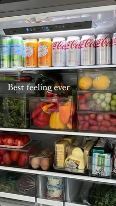 an open refrigerator filled with lots of fresh fruits and veggies next to drinks