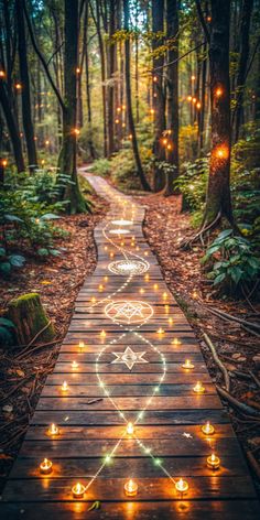 a path in the woods with lit candles on it and an image of a heart