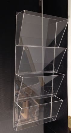 an acrylic display case is hanging on the wall in front of a black background