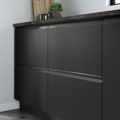 an image of a kitchen setting with black cabinets