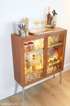 a wooden cabinet filled with liquor bottles and glasses