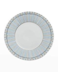 a blue and white plate with an ornate design on the rim, against a white background