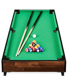 a pool table with cues and balls on it