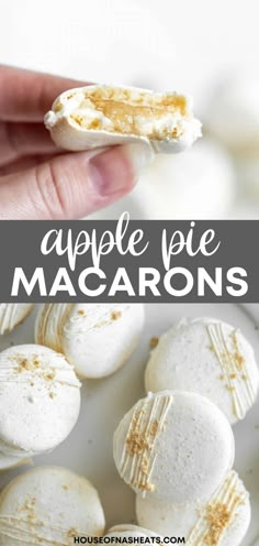 a hand holding an apple pie macarons over a white plate with the words apple pie macaroons on it