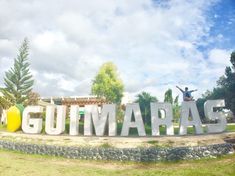 a man standing in front of a sign that says gummapass