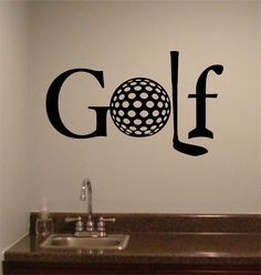 a golf ball on the wall next to a sink