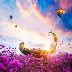 an image of hot air balloons flying in the sky over purple flowers and pink flowers