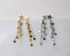 "more cute and fun necklaces and earrings in DearDanielleJewelry: https://www.etsy.com/shop/DearDanielleJewelry?ref=seller-platform-mcnav§ion_id=28417638 Shooting Star Earrings,Celestial Dangle Earrings. Star cascade, Star fall earring. Gold starry. Tiny sparkling little stars. 5/8\" diameter hammered gold plate star, 3\" drop Please choose your star color : Gold. Silver **framed gems, and charms in the jewelry is plated. *All the jewelry in my shop will be sent in cotton pouch. If you want gift Fall Earring, Star Earrings Dangle, Gold Star Earrings, Silver Star Earrings, Earrings Star, Starburst Earrings, Earring Gold, Fall Earrings, Sparkly Earrings