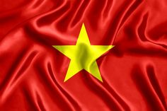 the flag of vietnam is waving in the wind with silky folds and bright yellow stars