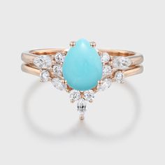 a turquoise and white stone ring with diamond accents