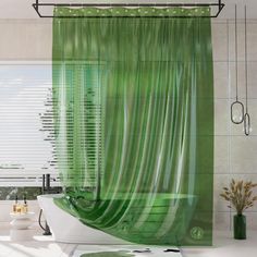 a bathroom with a green shower curtain next to a bathtub