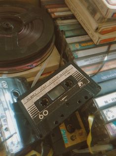 an old fashioned cassette player surrounded by tapes