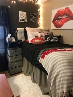 a bedroom decorated in black, white and red with lights on the wall above the bed