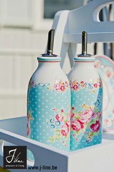 two blue vases sitting on top of a white table