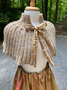 This terrific tweed shawl is hand knit of a soft beige wool with a subtle golden mustard thread throughout. The closure is a classic golden satin.  Whether you wear it to a ballgame or a Ren Faire, it is the perfect layering piece.  9" deep plus 4" collar Soft Beige, Shawls And Wraps, Layering Pieces, Scarf Wrap, Hand Knitting, Scarf Accessory, Shawl, Bathing Beauties, Satin