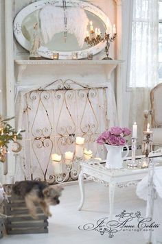 a living room filled with furniture and a fire place next to a fireplace covered in candles