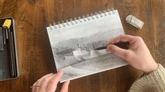 a person is drawing on a piece of paper