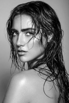 a woman with wet hair is posing for the camera