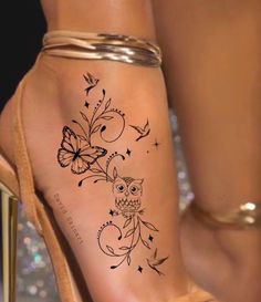 a woman's foot with an owl and butterfly tattoo on the left side of her leg