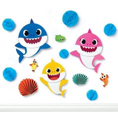 three paper cutouts of sharks and other sea creatures